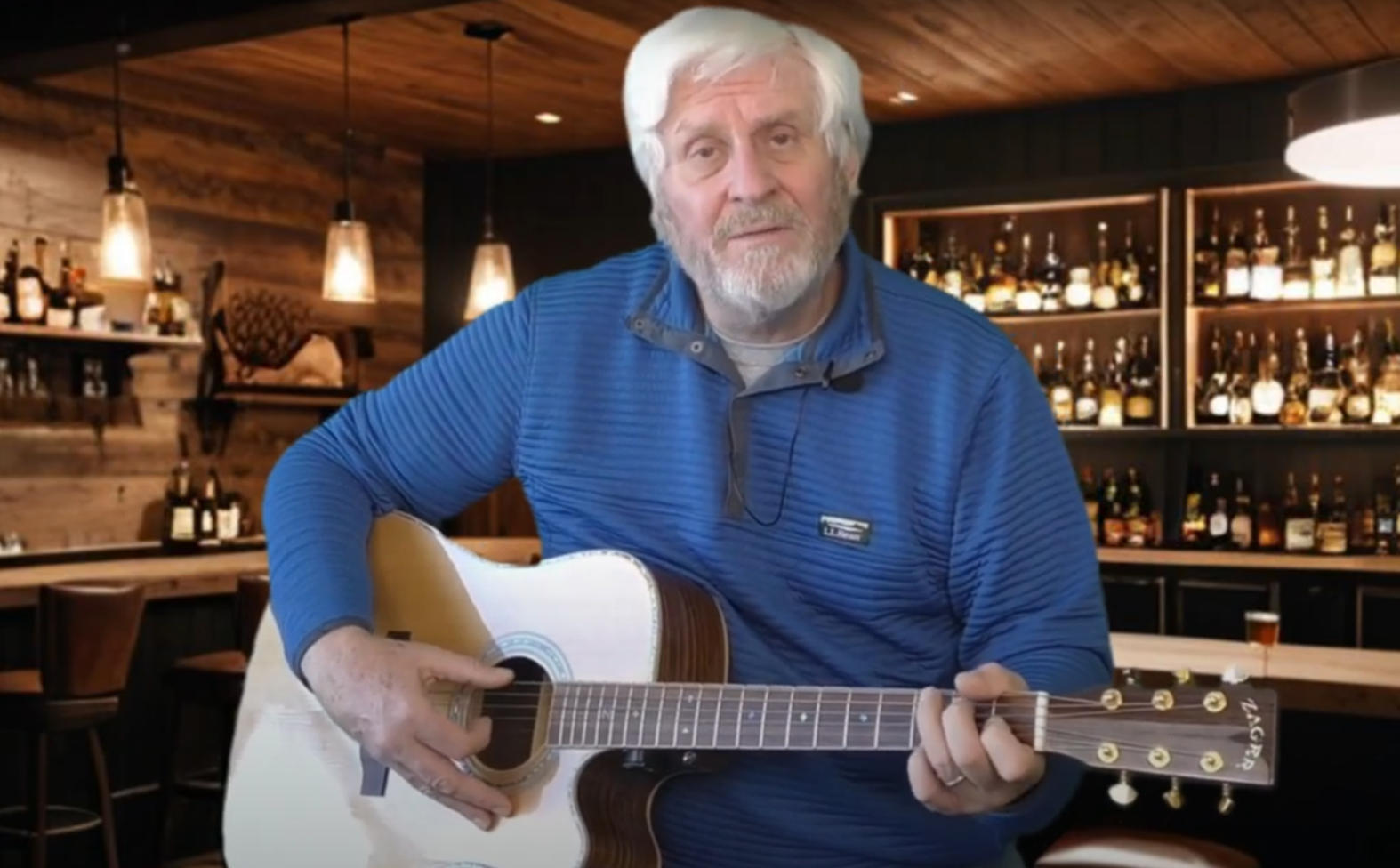 Bruce Lande with guitar at the bar
